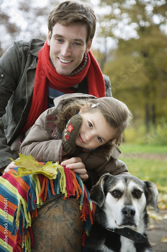 Photo: Father and daughter smiling with dog Father and daughter smiling with dog