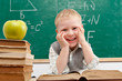 Cheerful smiling  little boy sitting at the table.