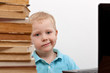 Cheerful smiling  little boy sitting at the table.