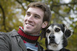 Young man with dog, smiling