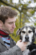 Young man with dog, close-up