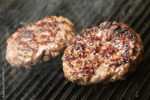 Photo: Beef Burgers Cooking on Griddle Beef Burgers Cooking on Griddle