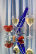 Two glasses of white wine with dark blue bottle and strawberries Two glasses of white wine with dark blue bottle and strawberries