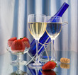 Two glasses of wine, dark blue bottle and strawberries Two glasses of wine, dark blue bottle and strawberries