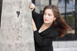 Businesswoman behind a tree Businesswoman behind a tree