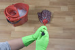 cleaner is mopping wooden parquet floor