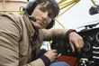Young man sitting in airplane, portrait