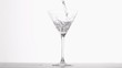 Gin poured in super slow motion in a glass
