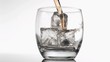 Whiskey poured in super slow motion in a glass with ice
