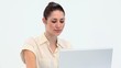 Young woman smiling while using a laptop
