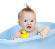 adorable baby having bath in blue tub