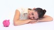 Woman with a piggy bank resting on a table