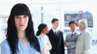 Businesswoman standing in front of her work team