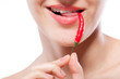 Young woman with chili pepper isolated on white
