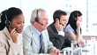 Serious call centre agents talking with headsets