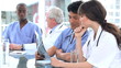 Medical people working on an x-ray while talking