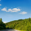 road in mountain under cloudy sky