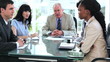 Smiling business team talking to each other