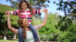 Video: Woman turning while carrying her daughter on the shoulders Woman turning while carrying her daughter on the shoulders