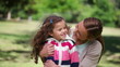 Video: Mother hugging her daughter while looking at camera Mother hugging her daughter while looking at camera