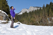 Alone trekking woman in the snowy mountains. Carpathians, Romani