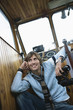 Young man holding binoculars, smiling