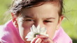 Peaceful little girl smelling a flower