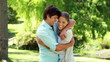 Smiling woman running and then embracing her boyfriend
