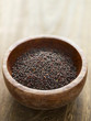 close up of a bowl of black mustard seeds close up of a bowl of black mustard seeds