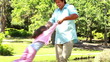 Little daughter being held by his father while turning