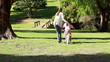 Rear view of a woman helping her daughter to ride a bike