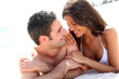 Portrait of romantic couple laying on the beach