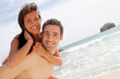 Portrait of man carrying girlfriend on his back