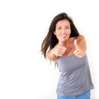 Charming young woman showing thumbs up, isolated