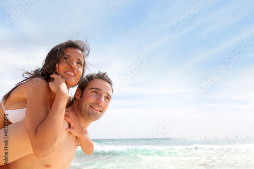 Photo: Portrait of man carrying girlfriend on his back Portrait of man carrying girlfriend on his back
