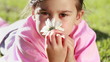 Happy girl holding a beautiful flower