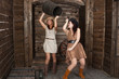 brunette and blonde CowGirls fighting in old depot