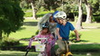 Video: Smiling mother fastening the helmets of her children Smiling mother fastening the helmets of her children