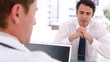 Video: Serious businessman talking to a doctor Serious businessman talking to a doctor