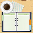 a coffee and a notebook on the desk