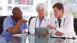 Video: Mature doctor using a touchscreen with her colleagues Mature doctor using a touchscreen with her colleagues