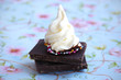 Meringue swirl on a chocolate pieces with colored balls
