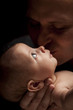 Young Father Holding His Mixed Race Newborn Baby