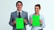 Two business people holding signs