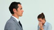 Man in suit wearing a surgical mask while a woman is sneezing