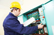 Electrician with drawing at power line box