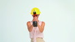 Woman with a safety helmet shooting with a screw gun 