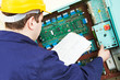 Electrician with drawing at power line box