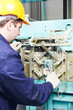 machinist with spanner adjusting lift mechanism