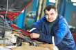 happy mechanic technician at service station